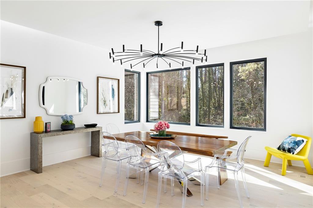The chef’s kitchen is a culinary delight, equipped with top-of-the-line stainless steel appliances, custom cabinets, quartz countertops, a spacious island, a meticulously designed walk-in pantry, and an open dining room perfect for entertaining.