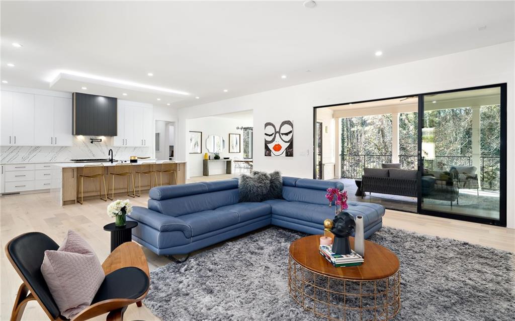 Inside, you'll discover a blend of luxury features, including high ceilings, oversized windows, wide plank hardwood flooring, designer lighting, custom cabinetry, and contemporary finishes.