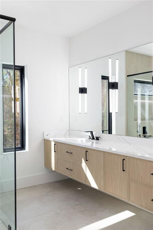 The spa-grade bathroom features featuring high-end fixtures, a spacious walk-in shower, a luxurious soaking tub, and designer finishes that create a serene atmosphere.
