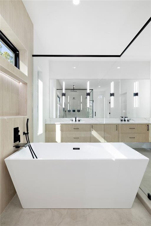The spa-grade bathroom features featuring high-end fixtures, a spacious walk-in shower, a luxurious soaking tub, and designer finishes that create a serene atmosphere.