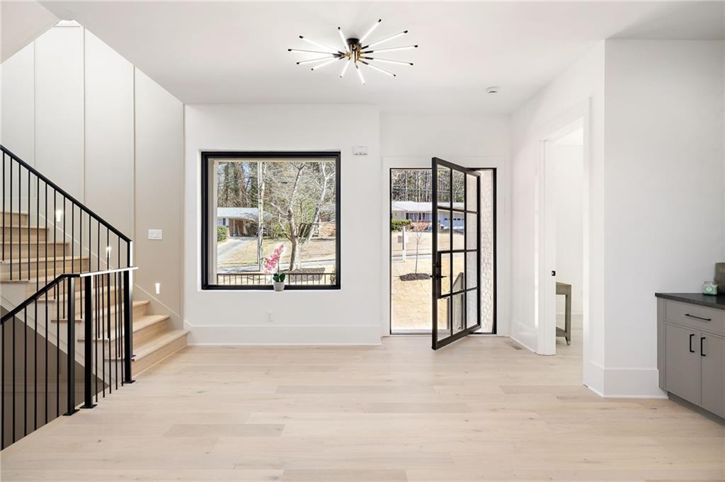 The expansive open layout encompasses a versatile study/bedroom with a full bath, a generously sized family room, a covered outdoor lounge, a chef’s kitchen, a mudroom, and a convenient 3-car garage.