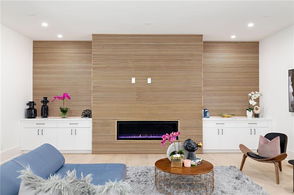 Inside, you'll discover a blend of luxury features, including high ceilings, oversized windows, wide plank hardwood flooring, designer lighting, custom cabinetry, and contemporary finishes.