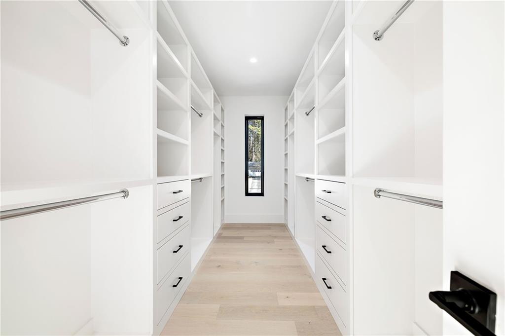 The spa-grade bathroom features featuring high-end fixtures, a spacious walk-in shower, a luxurious soaking tub, and designer finishes that create a serene atmosphere.