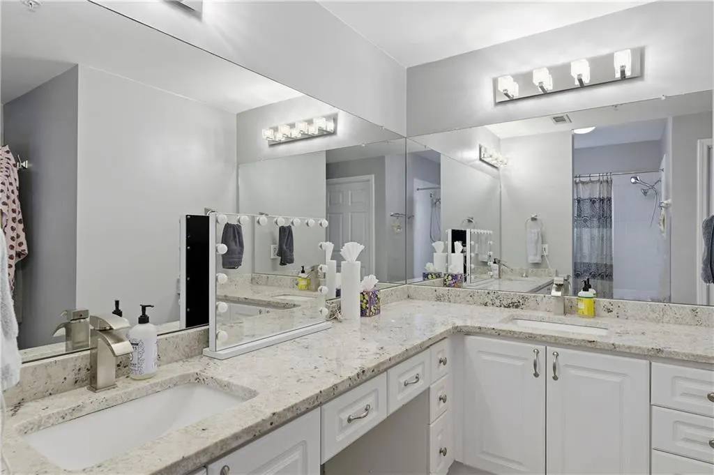 Bathroom featuring double vanity and a shower with curtain