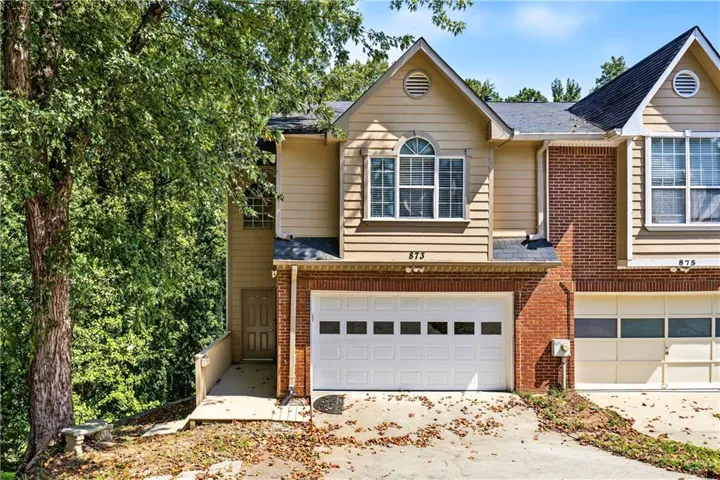 Brick and siding exterior with an attached garage