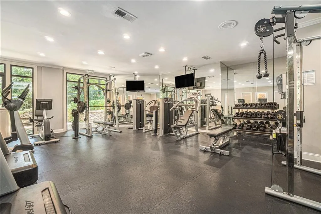 Workout area with recessed lighting and baseboards