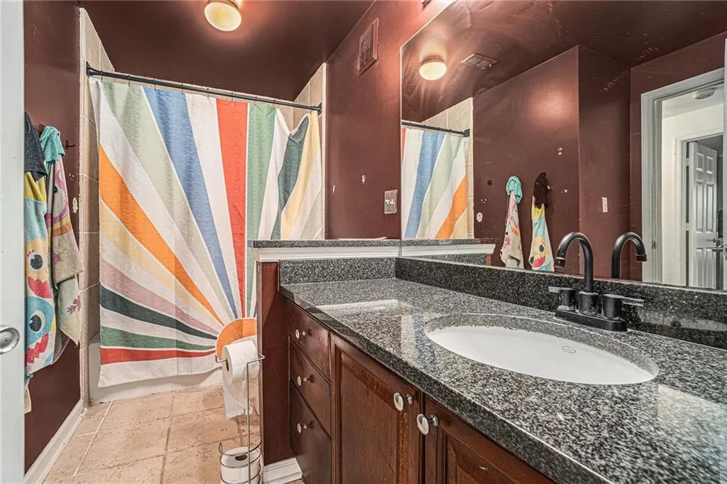Bathroom featuring vanity and stone tile floors