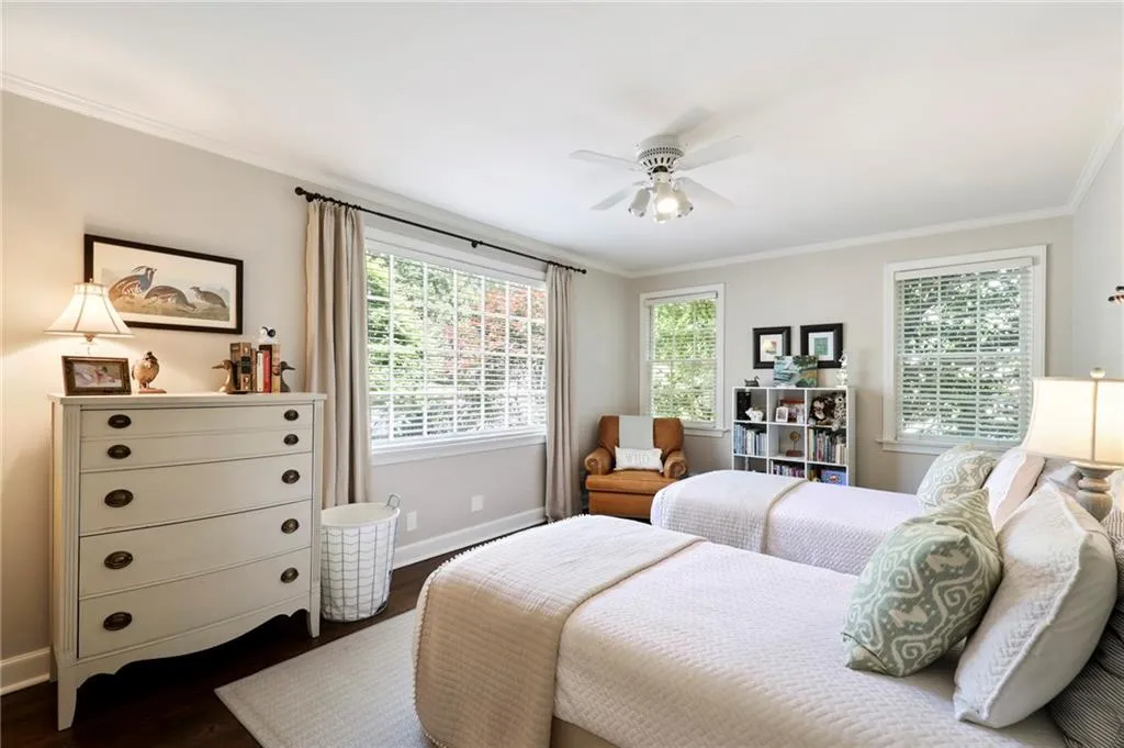 Bedroom featuring ornamental molding, wood finished floors, and ceiling fan