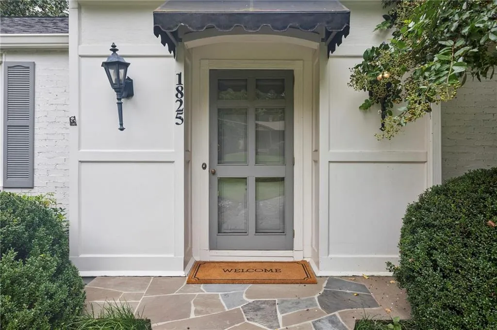 View of exterior entry with brick siding