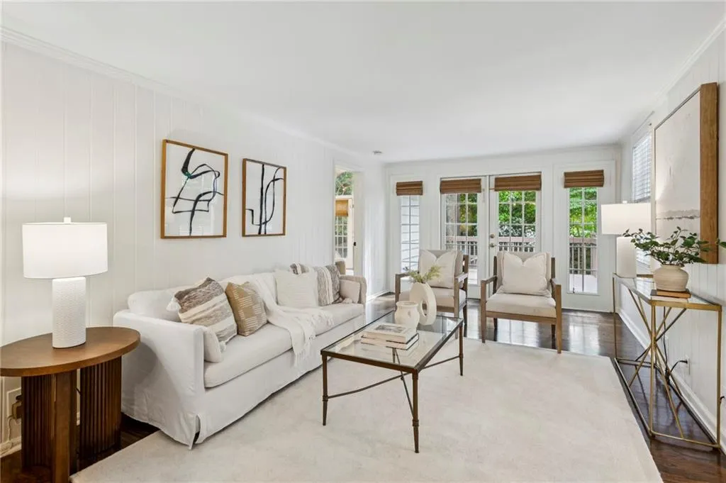 Living room with wood finished floors and crown molding