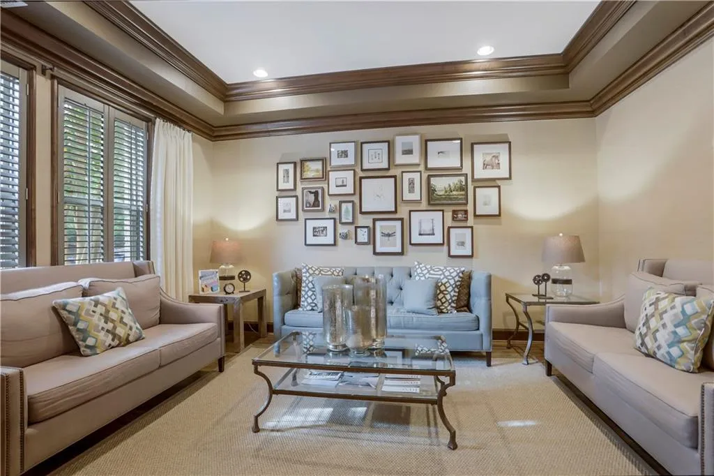 Living room with a tray ceiling and ornamental molding