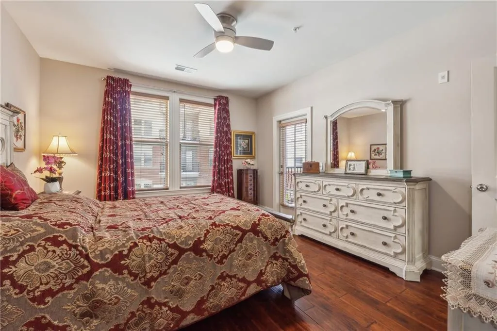 Bedroom featuring dark hardwood / wood-style flooring and ceiling fan