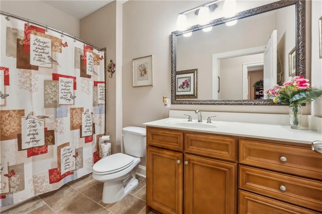 Bathroom with toilet, tile floors, and vanity