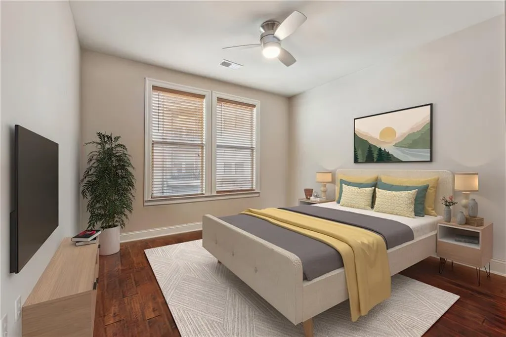 Bedroom featuring dark hardwood / wood-style floors and ceiling fan