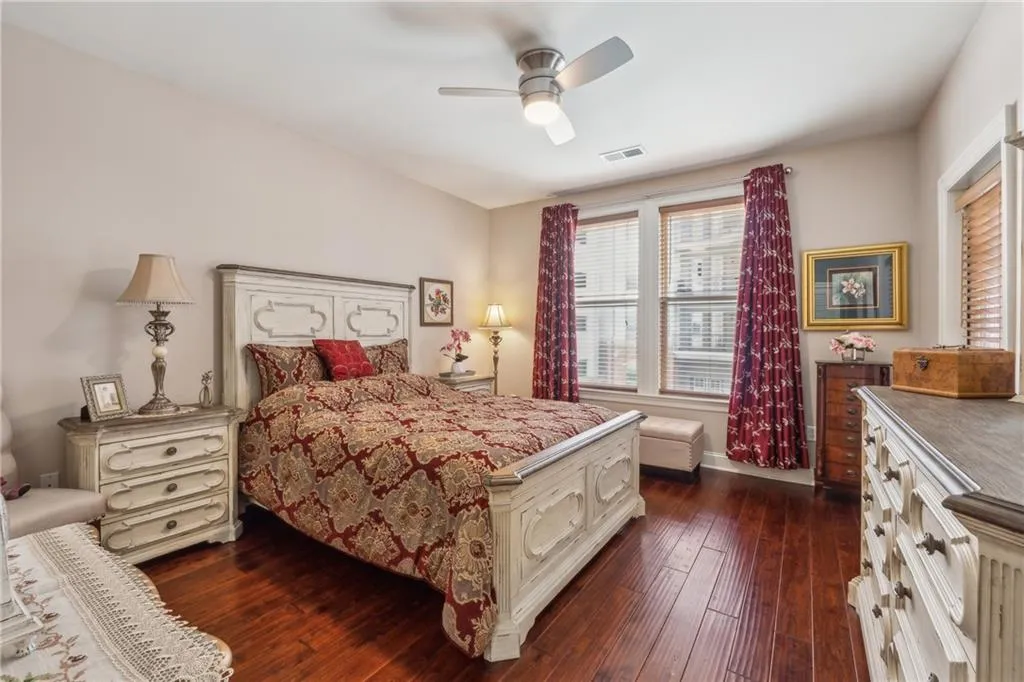 Bedroom with ceiling fan and dark hardwood / wood-style floors