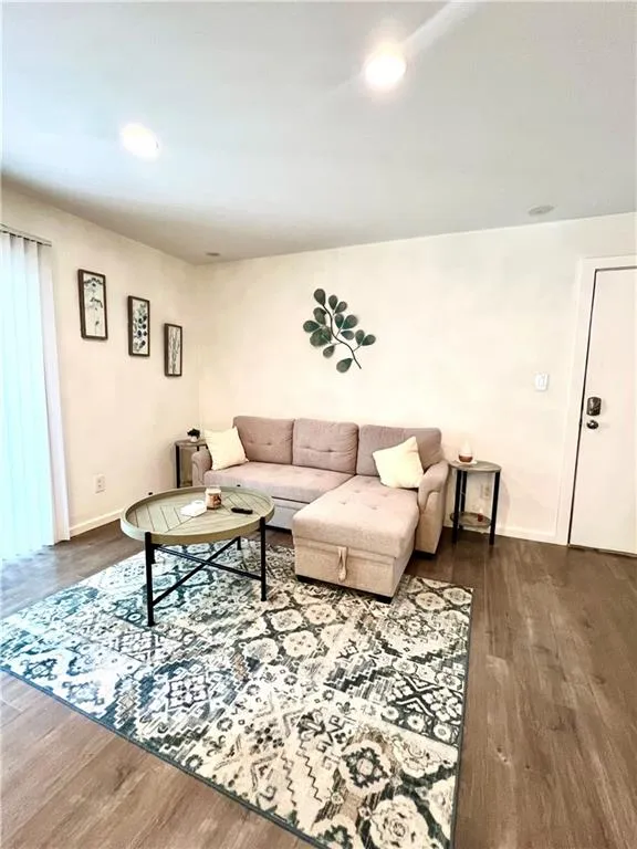 Living room featuring glimpse of sliding glass patio doors with safety latch