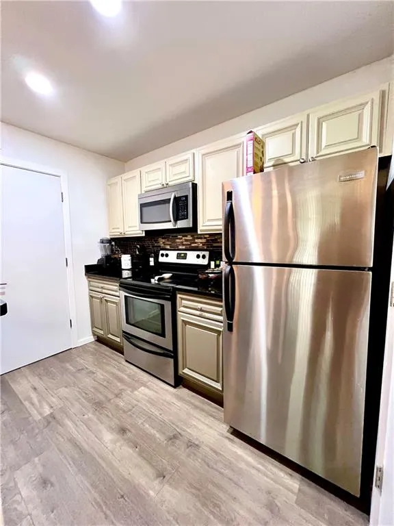 Kitchen with backsplash and stainless steel appliances