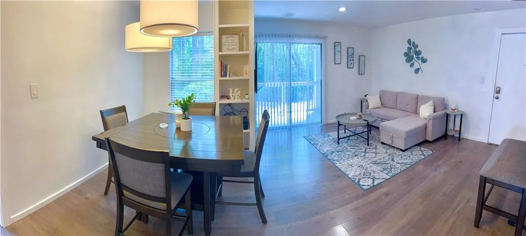 Separate dining & living room space featuring built-in bookcase