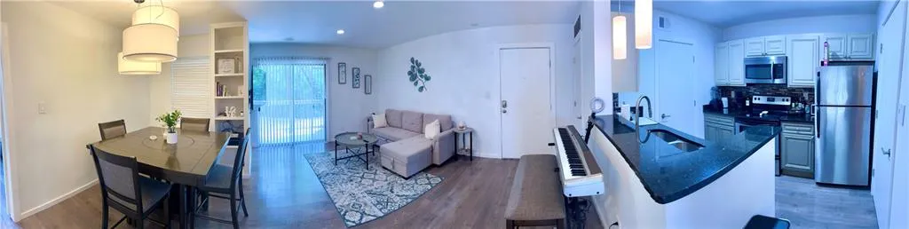 Panoramic view of living room, dining room, and kitchen