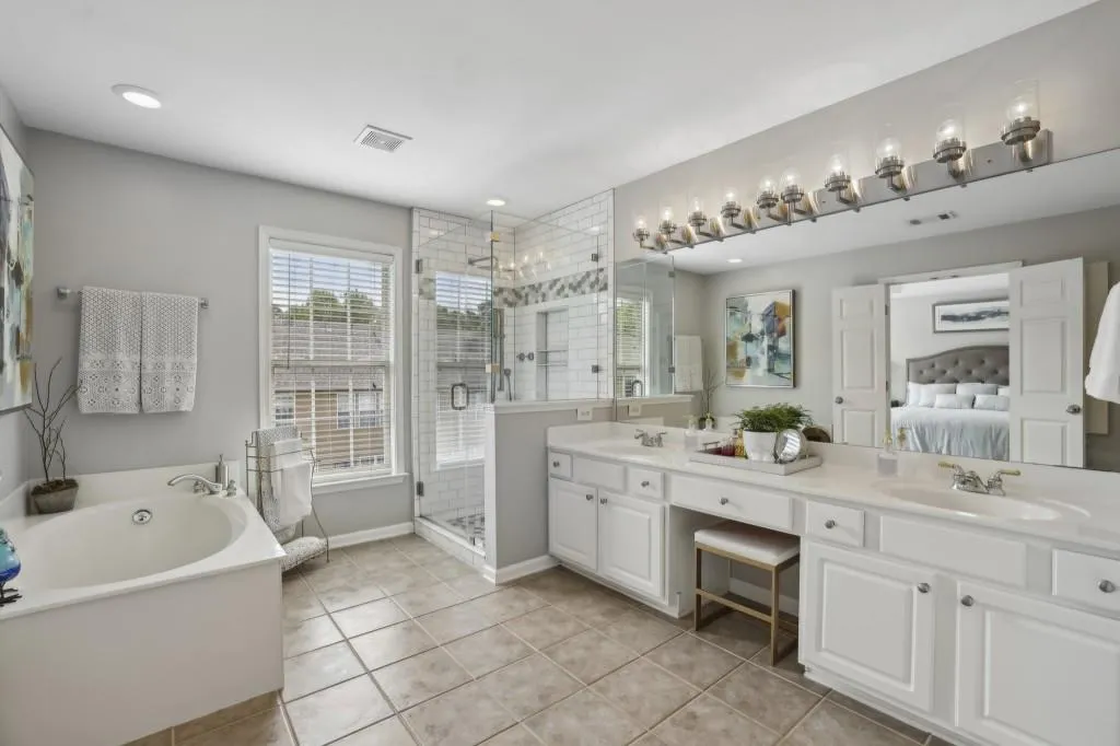 Primary Ensuite With Dual Vanities, A Large Soaking Tub, & Separate Tiled Shower