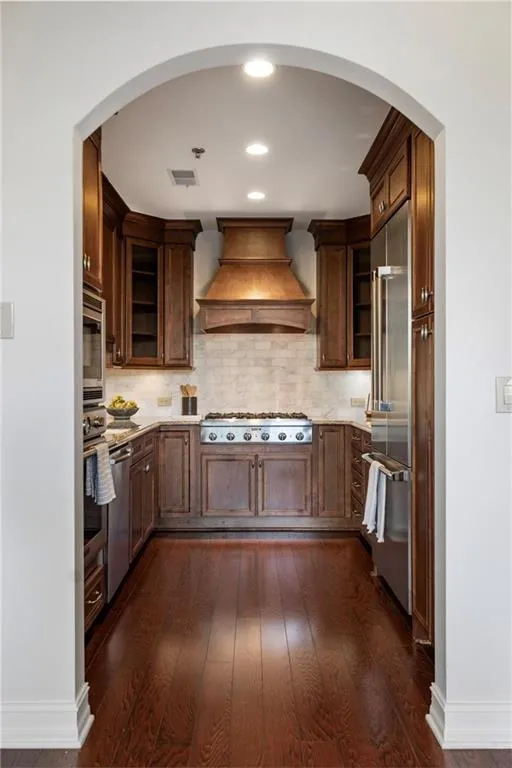 High-End Kitchen with Stainless Steel Appliances Opens Beautifully to Living and Dining Room.
