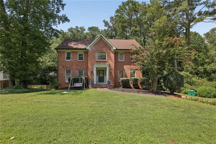 Brick exterior with a gabled roof and white trim