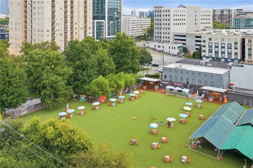 Expansive turf area with distinct covered sections and multiple seating arrangements