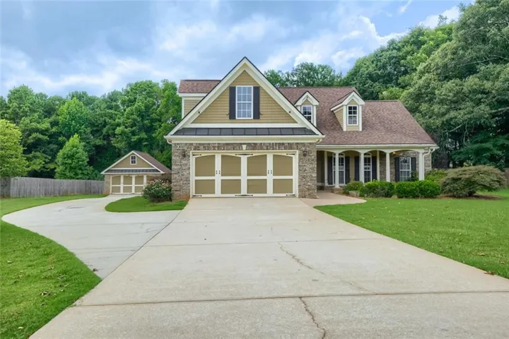 Traditional style home featuring stone accents and dormer windows