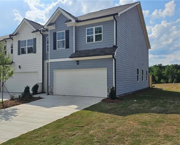 Contemporary two-story residence featuring light blue horizontal siding and a white trim