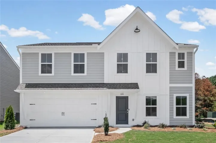 Modern farmhouse exterior featuring vertical white siding and horizontal gray siding