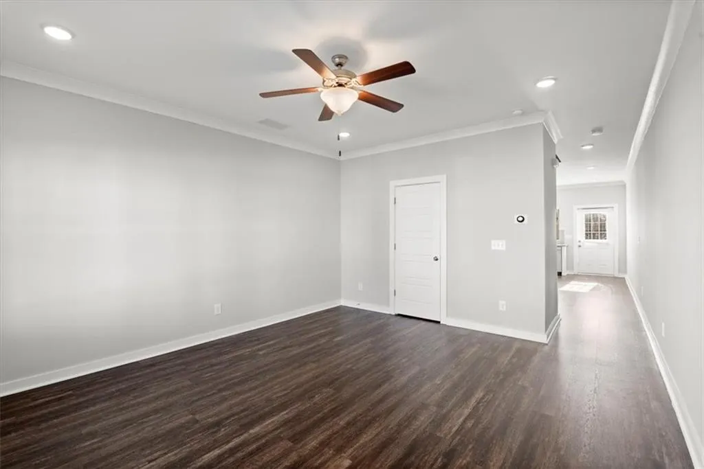 Unfurnished bedroom featuring ornamental molding, recessed lighting, dark wood finished floors, and a ceiling fan