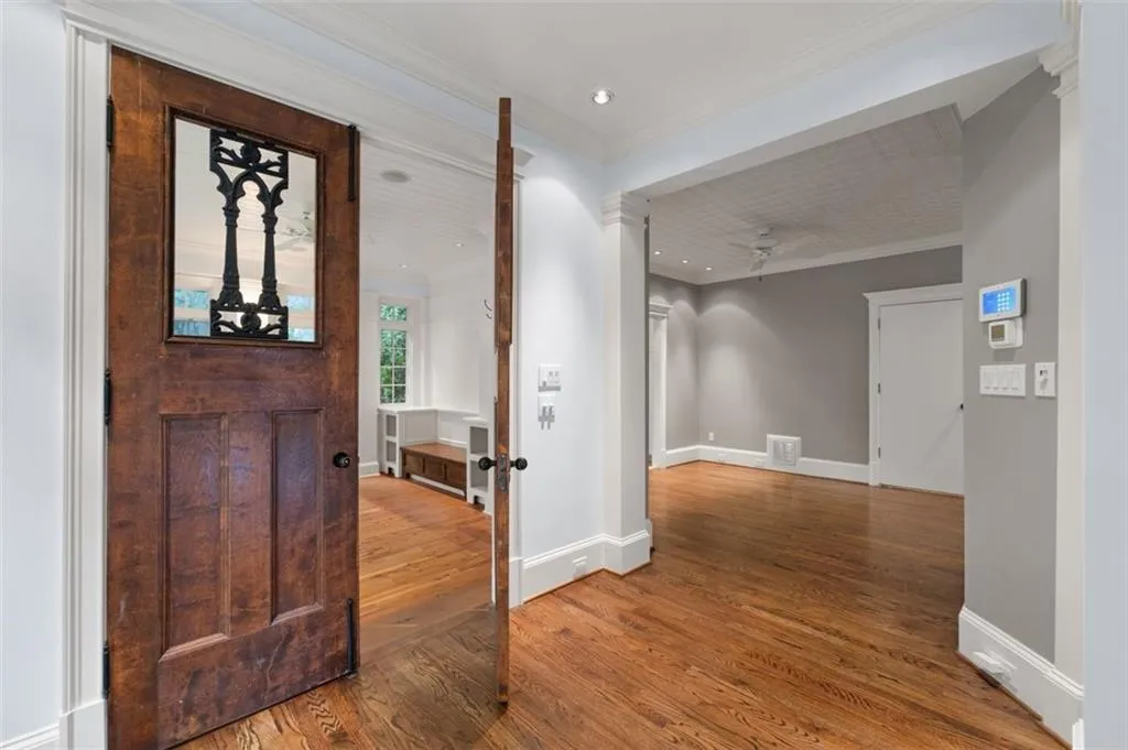 Beautiful wood doors open to the sunroom.