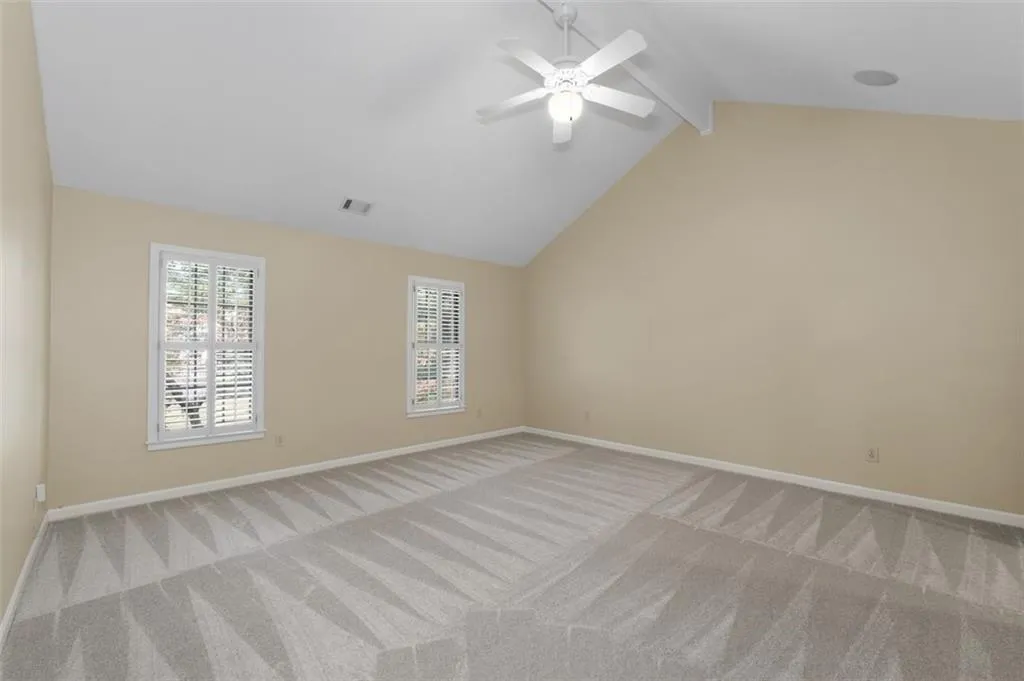 Vaulted primary suite has new carpet & a walk-in closet
