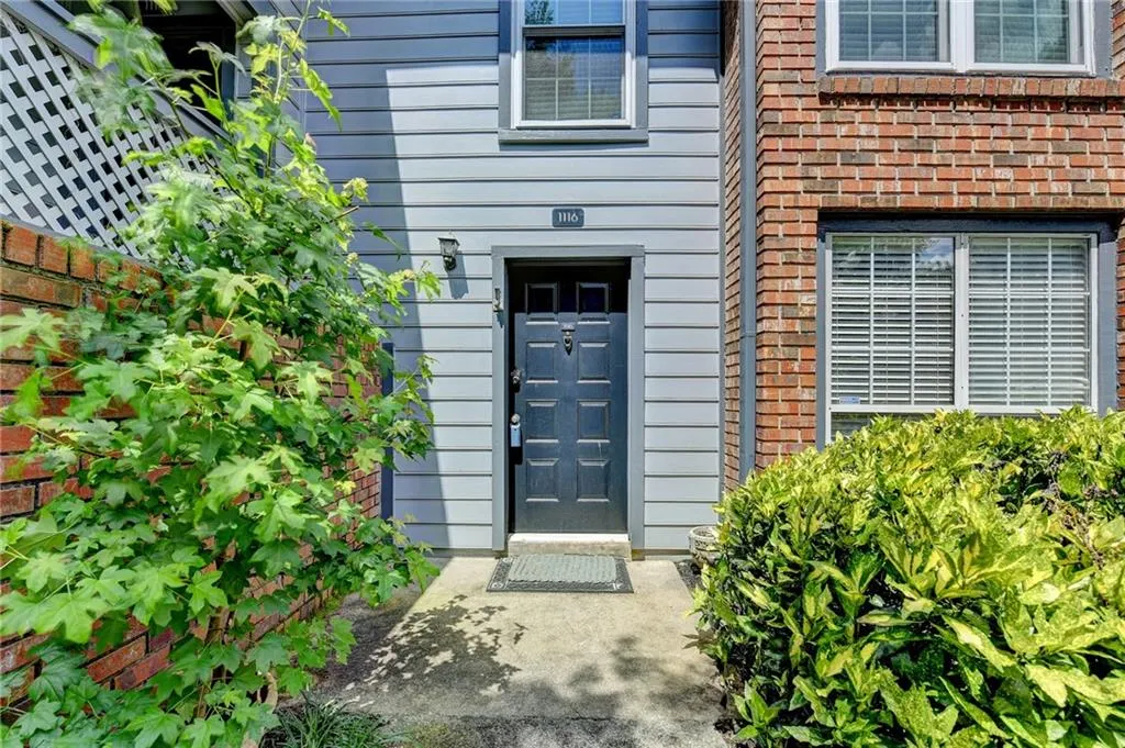 View of exterior entry with brick siding