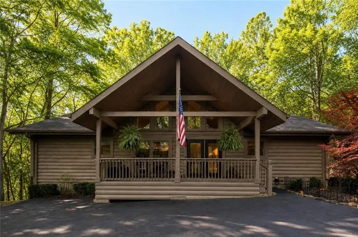 2007 Log siding exterior with an A-frame portico, covered porch, and double entry doors