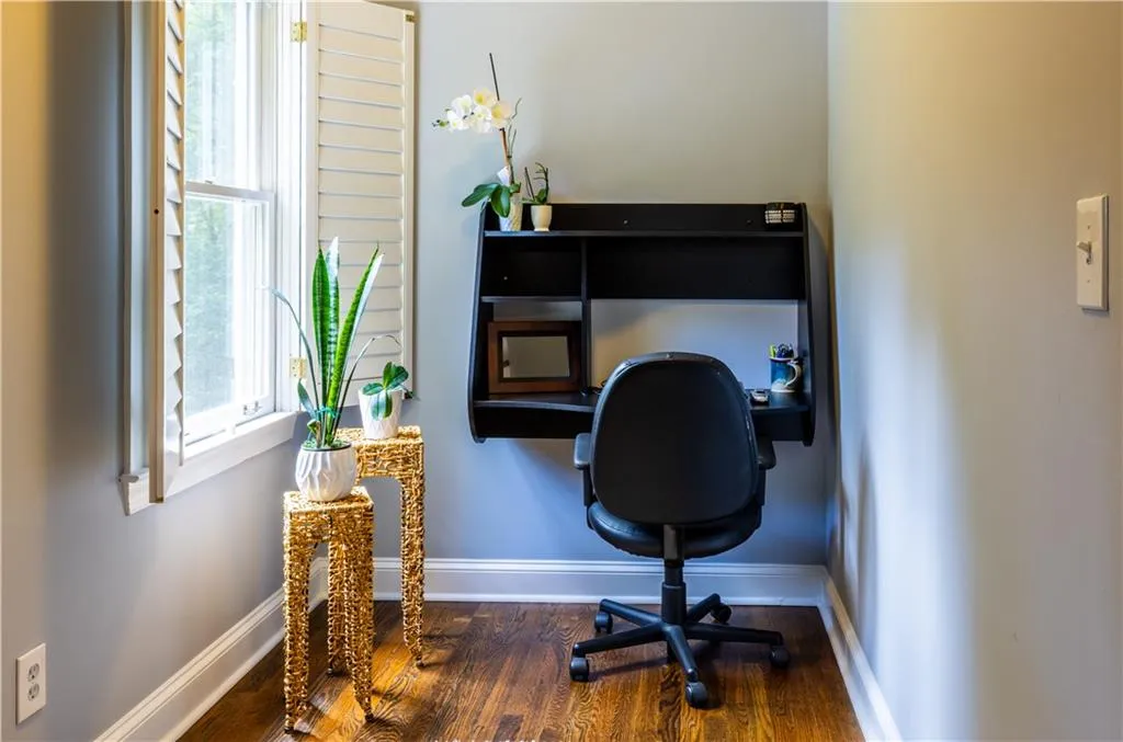 Office with wood finished floors and baseboards