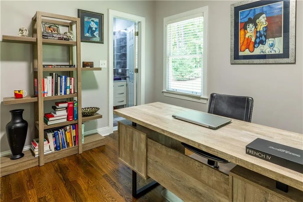 Office area with dark wood-type flooring and baseboards