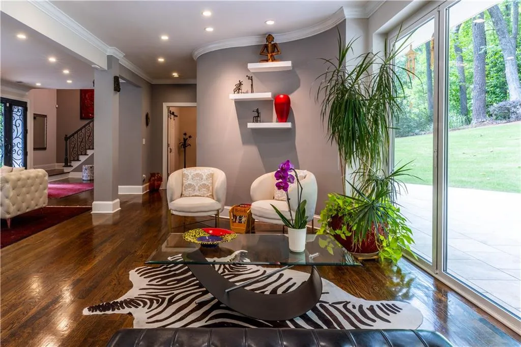 Living area with wood finished floors, recessed lighting, stairway, ornamental molding, and baseboards