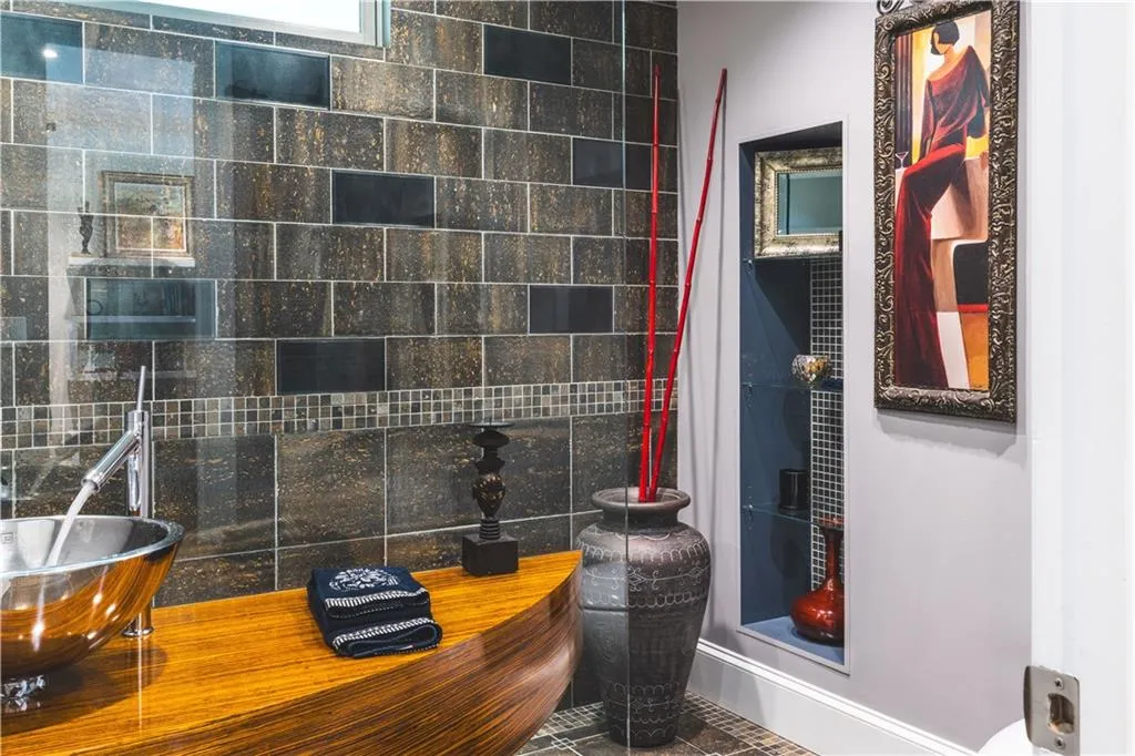 Bathroom featuring a sink and baseboards