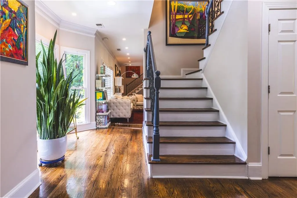 Staircase featuring wood finished floors, baseboards, ornamental molding, and recessed lighting