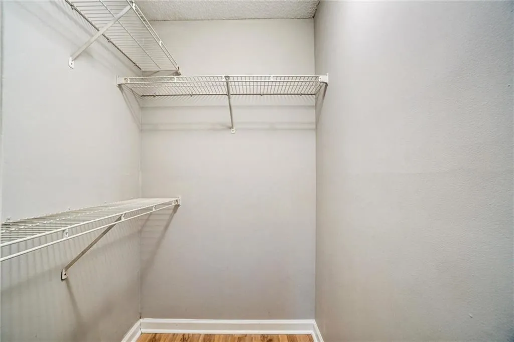 Walk in closet featuring light wood-style floors