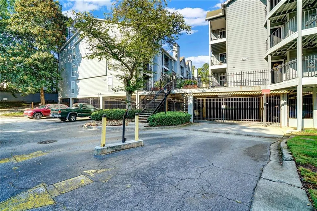 View of property featuring uncovered parking and stairs
