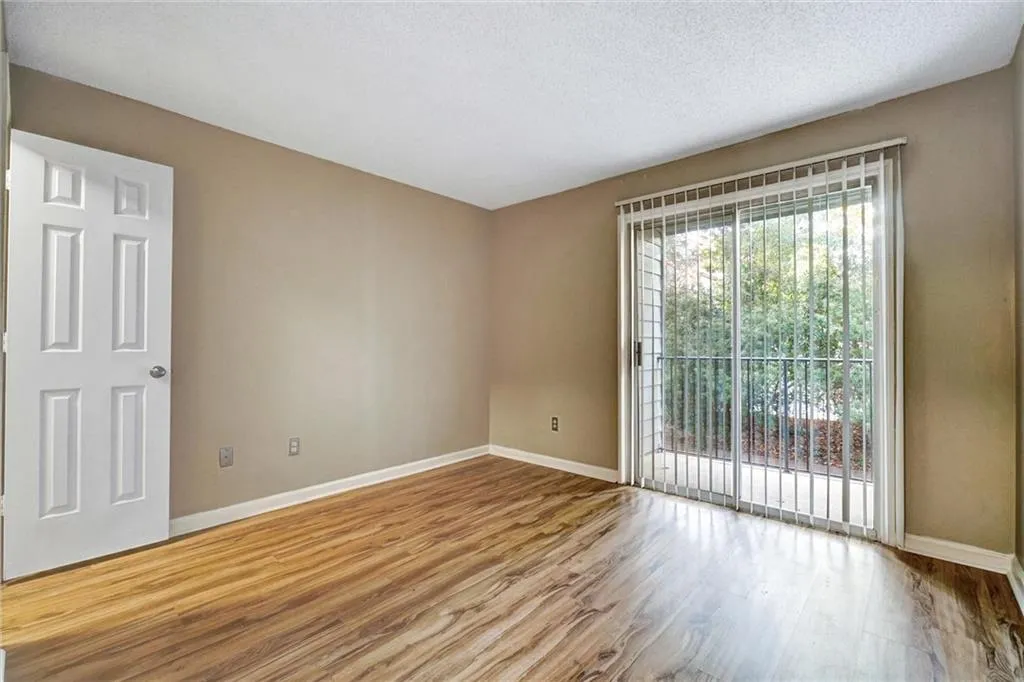 Spare room with light wood finished floors and a textured ceiling