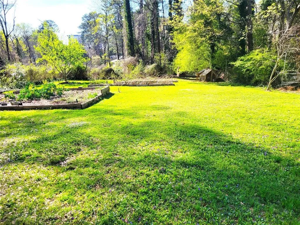 View of grassy yard with a garden