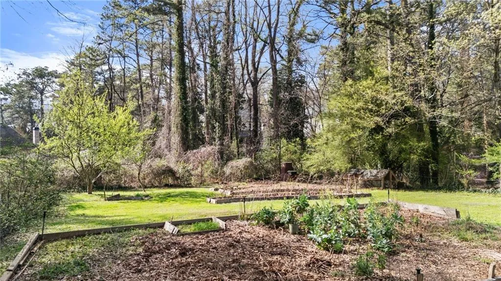 View of grassy yard with a garden