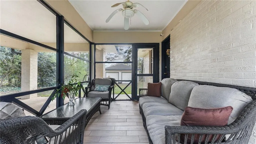 Sunroom / solarium with ceiling fan and outdoor lounge area