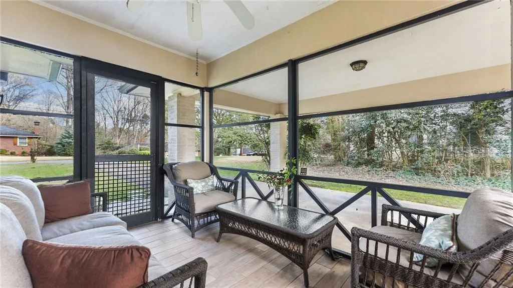 Sunroom featuring outdoor seating, ceiling fan, and plenty of natural light