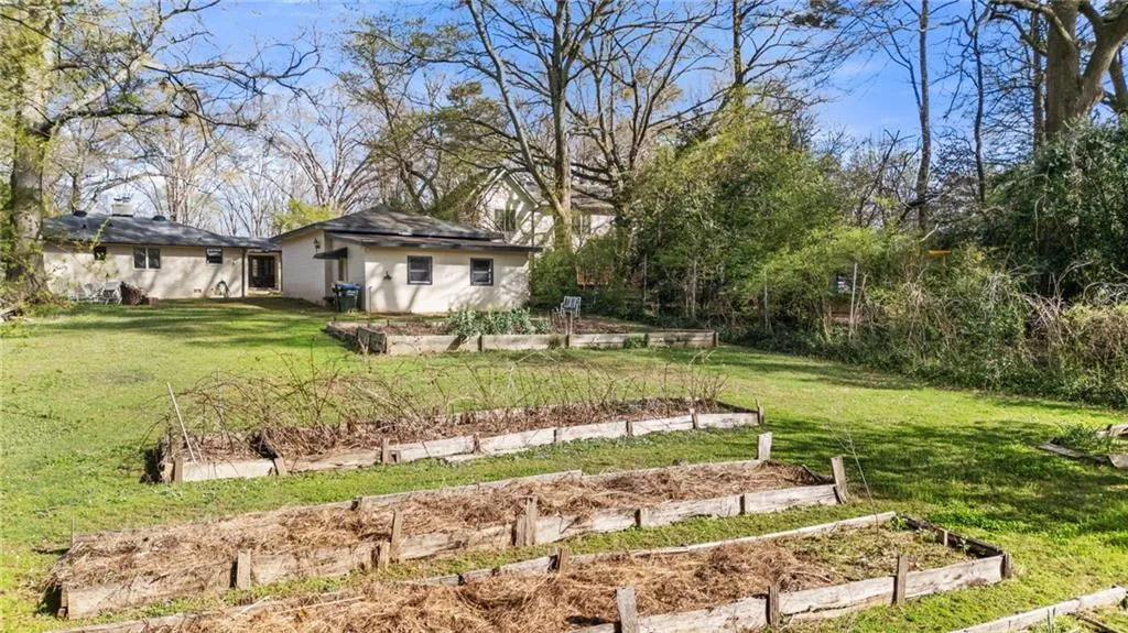 View of green lawn with a garden