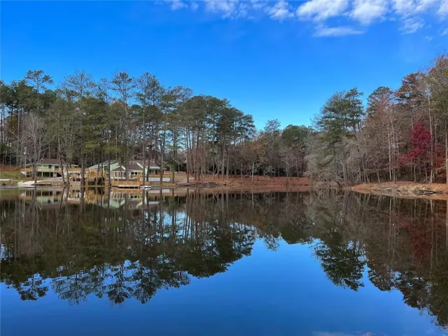 Beautiful water view of private lake with wooded shoreline and peaceful natural surroundings.