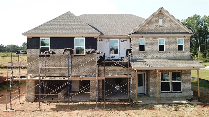 Brick facade construction with a covered porch and gabled roofline